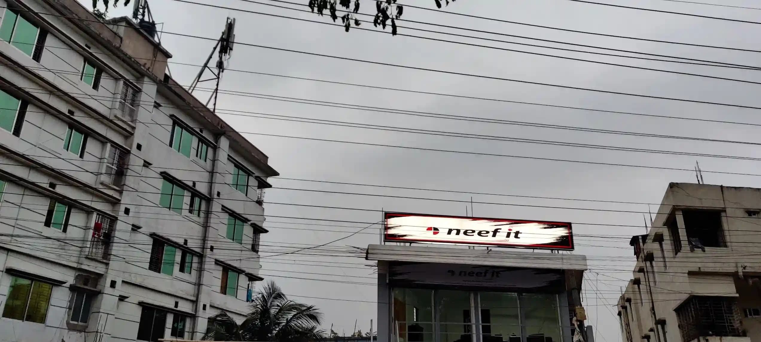 Neef It broadband office exterior with illuminated signage at Hallgate Boteshwar, Sylhet